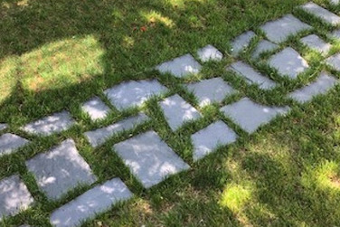 pathway made of slate flagstone pieces in the grass